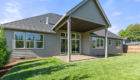 Fenced backyard with green grass, covered patio. Lot 1 in Martin Meadow by Glavin Homes.